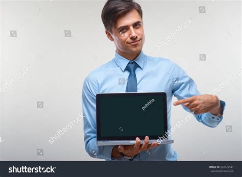 Business Man Holding Laptop Against White Stock Photo 222627541