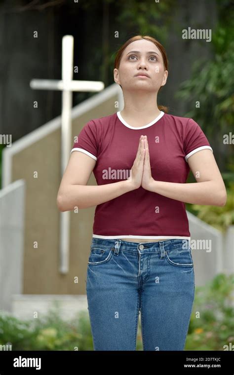 A Filipina Woman Praying With Cross Stock Photo Alamy