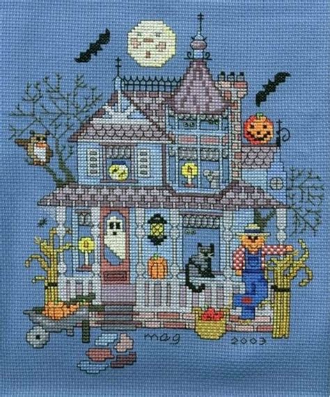 A Cross Stitch Halloween House With Bats And Pumpkins