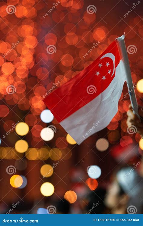 Hand Waving Singapore Flag during Singapore`s 54th National Day Parade ...