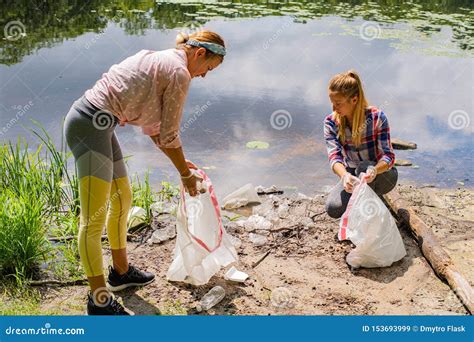 Volunteers Cleaning Garbage Near River. Women Picking Up a Bottle Plastic in the Lake, Pollution ...