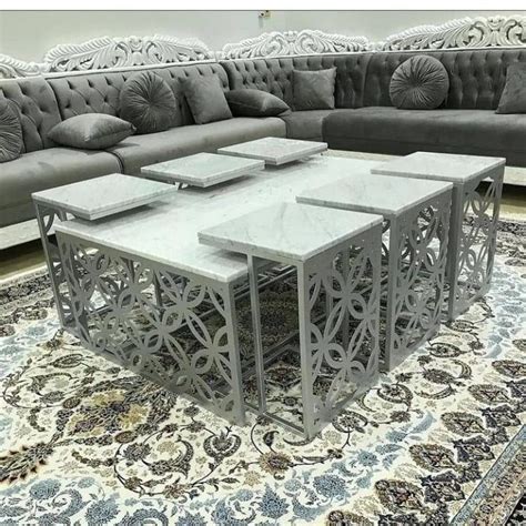 Three Tables Sitting On Top Of A Rug In Front Of A Couch