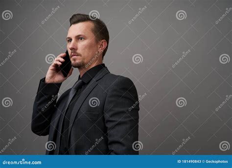 Close Up Portrait Of Handsome Young Businessman Using Smartphone Stock