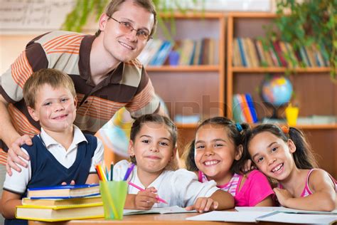 Group Of Pupils In Classroom With Teacher Stock Image Colourbox