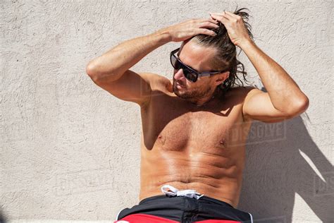 The Handsome Brutal Man In Sunglasses With A Long Hair And Naked Torso