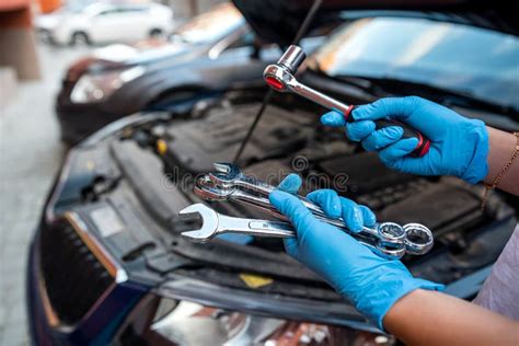 Car Mechanic Repairman Hands Repairing Car Engine Of Car Workshop With