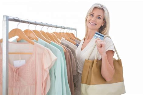 Premium Photo Pretty Blonde Smiling At Camera By Clothes Rail