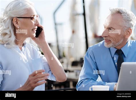 Positive Delighted Blonde Holding Telephone Near Left Ear Stock Photo