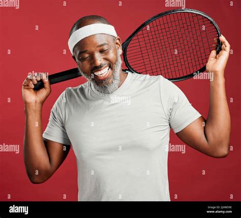 One Happy Mature African American Man Standing Against A Red Background