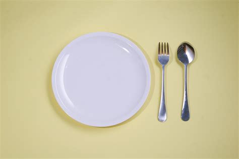 Empty Plate With Spoon Yellow Background 6415910 Stock Photo At Vecteezy