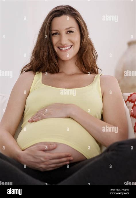 A Great Adventure Is About To Begin Portrait Of A Young Pregnant Woman In Her Living Room Stock