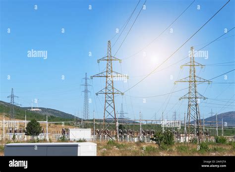 Electricity Transmission Pylons Against Blue Sky High Voltage