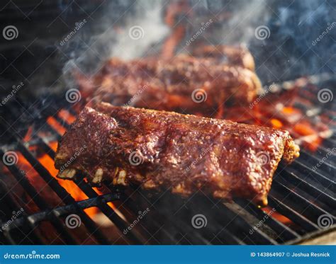 Bbq Pork Ribs Cooking On Flaming Grill Stock Image Image Of Smoke