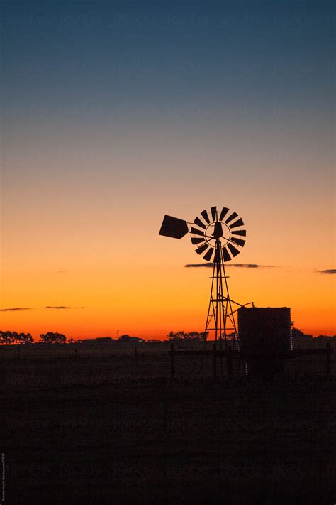 Old Farm Windmill At Sunset By Stocksy Contributor Rowena Naylor