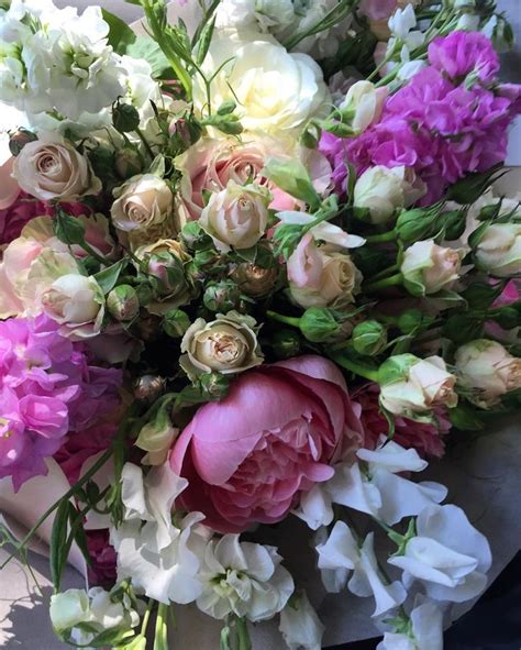 A Bouquet Of Flowers Sitting On Top Of A Table