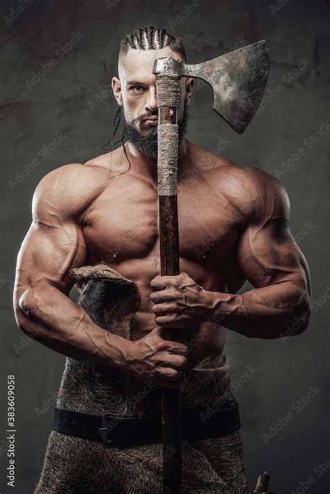 Bodybuilder In Fashion Of Furious Viking Posing Holding Axe Near Face