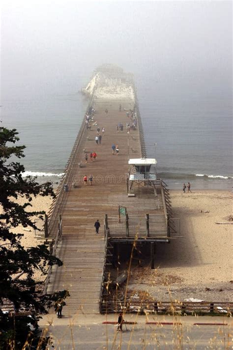 Tourists And Locals Enjoy The Walk On The Historic Wooden Pier At