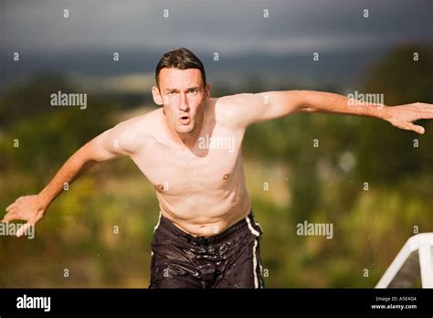 Man Jumping Into Swimming Pool Stock Photo Alamy