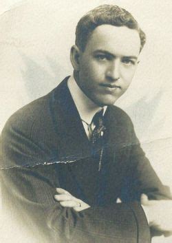 An Old Black And White Photo Of A Man In A Suit With His Arms Crossed