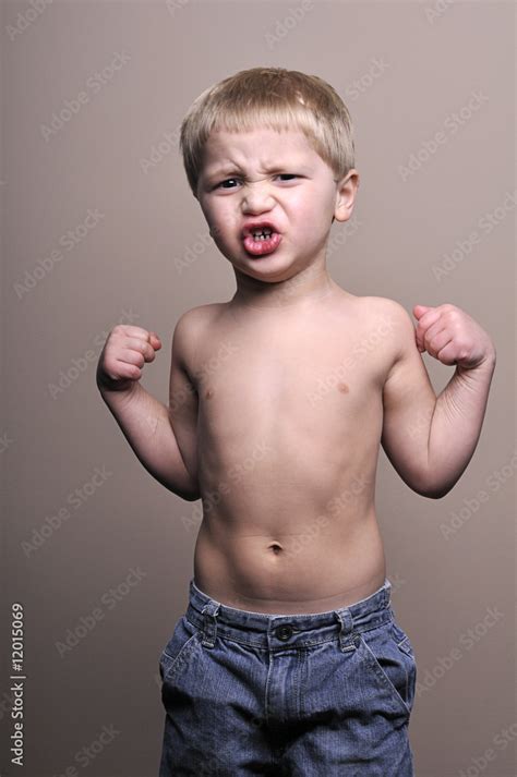 Little boy flexing muscles Stock Photo | Adobe Stock