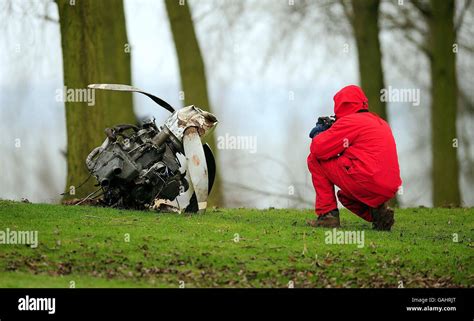 An air crash investigator looks at the engine from a privately owned ...