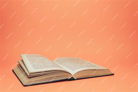 Premium Photo Open Old Book On A Beautiful Coral Orange Background