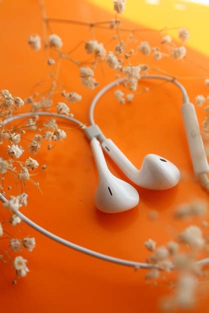 Premium Photo White Headphones Orange Background Listening To Music