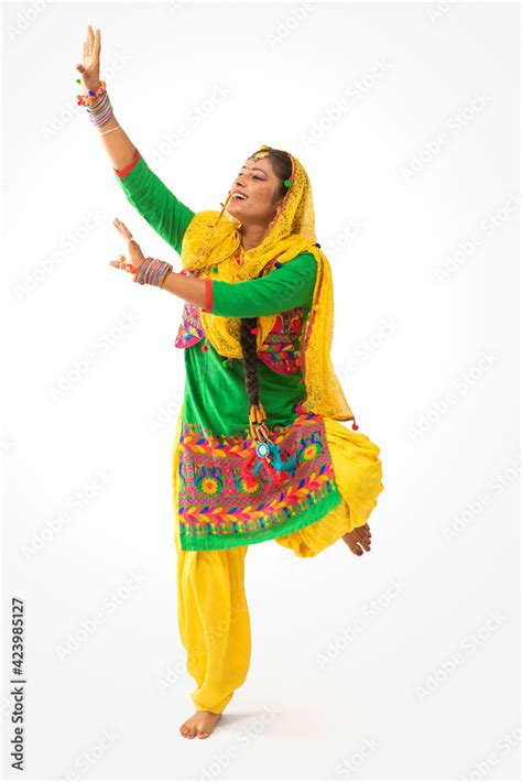 A Giddha dancer performing a dance step with hand gestures. Stock Photo | Adobe Stock