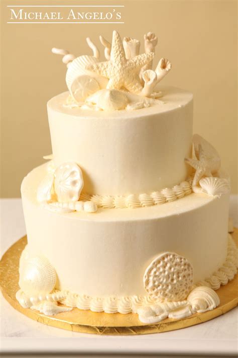 Small Sea Shells Specialty This Two Tier Cake Is Iced In Ivory