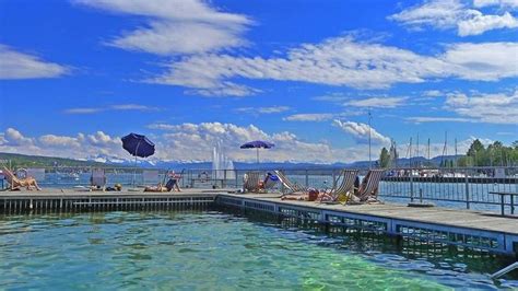 people are relaxing on the dock by the water