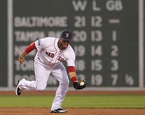 A Baseball Player Is Running On The Field