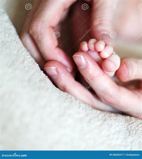 Hands Holding Tiny Foot Of Newborn Baby Stock Image Image Of Bright