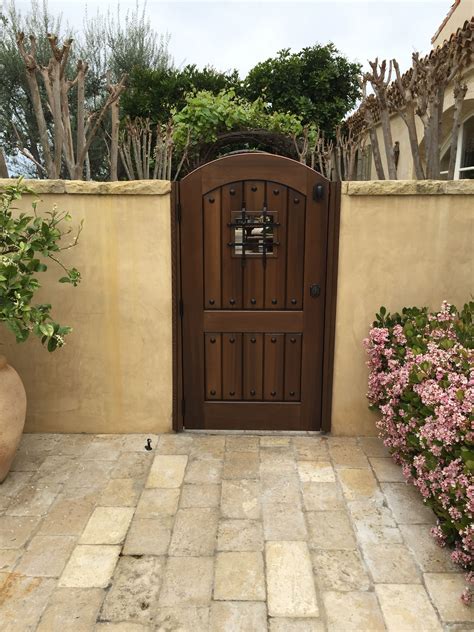 an entrance to a home with flowers in the foreground