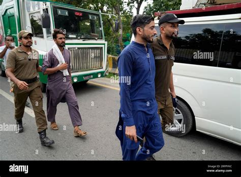 Police Officers Detain A Supporter Of Pakistans Former Prime Minister