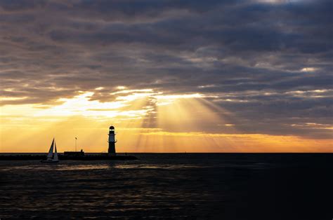 Silhouette of lighthouse during sunset photo – Free Warnemünde Image on ...