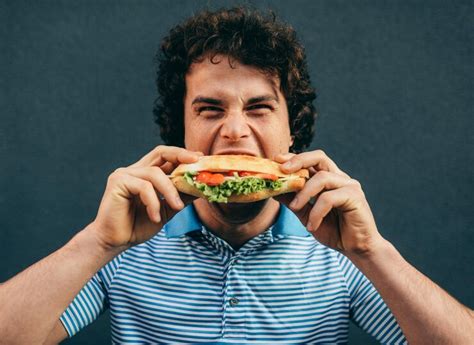 Premium Photo Closeup Portrait Of Young Handsome Man Eating A