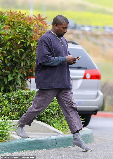 Kanye West Fuels Up At A Luxury Store Wearing New Yeezy Sockshoe