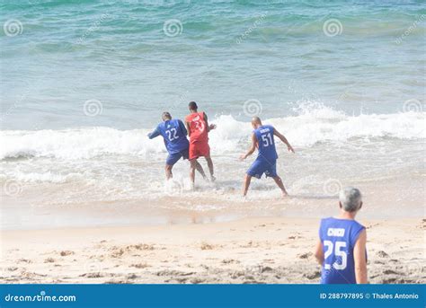 People Have Fun Playing Beach Soccer At Farol Da Barra Beach In The