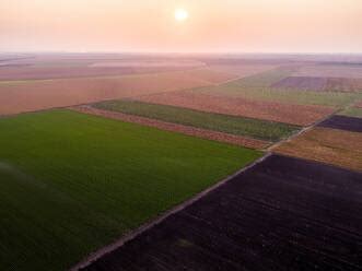 Aerial View Of Vast Agricultural Farm Fields At Summer Dusk Stock Photo