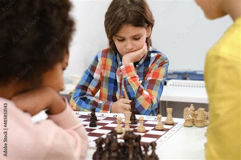 Diverse Group of kids playing chess. Concentrated multiethnic clever ...