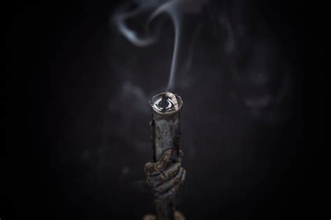 Premium Photo Old Vintage Black Metal Candlestick With Smoke From An