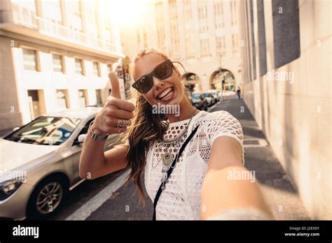 Tourist Posing For A Selfie In A Street Flashing Thumbs Up Sign Vlogger Recording Content For