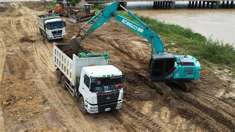 Kobelco Sk Excavator Clearing Soil Loading Dump Trucks