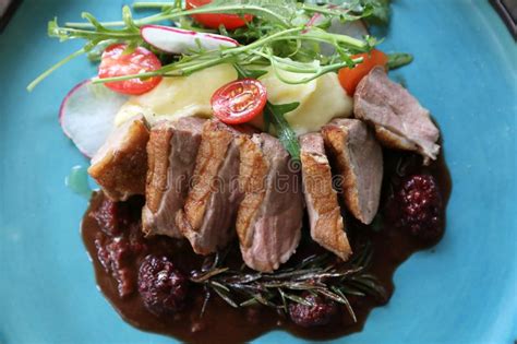 Duck Confit With Salad , Baked Apple And Raspberry Sauce Stock Photo - Image of apple, gourmet ...