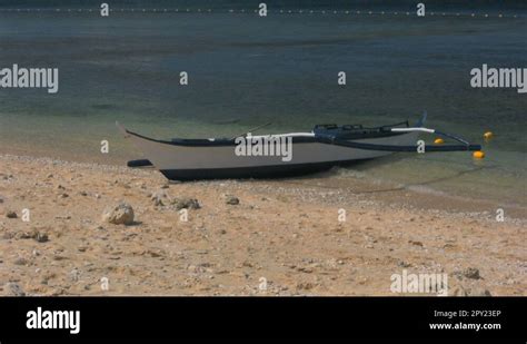 Traditional Filipino Banka Outrigger On A Sand Beach In Philippines