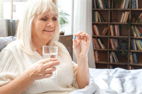 Senior Woman Resting At Home In Bed Taking Pill Elderly Lifestyle Stock