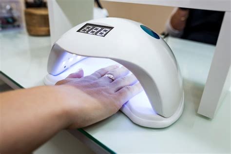 Premium Photo Female Hand With Manicured Nails Inside A Uv Lamp In A