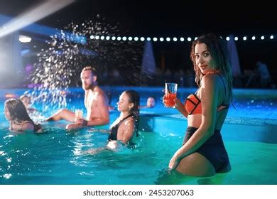 Pretty Woman Bikini Drinking Cocktail Hanging Stock Photo