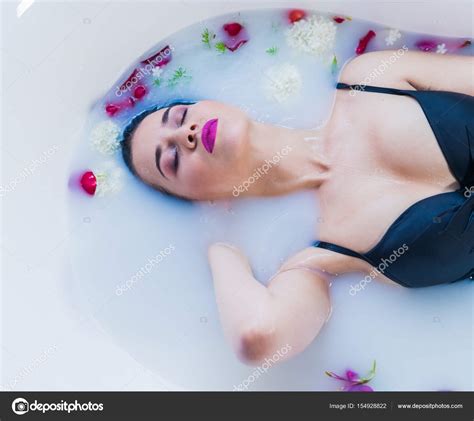 Sexy Brunette Woman Relaxing In Hot Milk Bath With Flowers Stock Photo By Igor Kardasov Gmail
