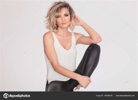 Sexy Blonde Woman Leather Pants White Undershirt Sitting White Background Stock Photo By